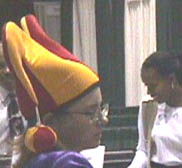 A jester mans a booth at ChariTECH