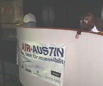 Hanging the AIR-Austin banner at Infotec